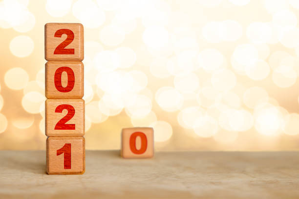 istock Welcoming New Year 2021 Wood Cube Blocks and Leaving 2020 Behind 1248282639