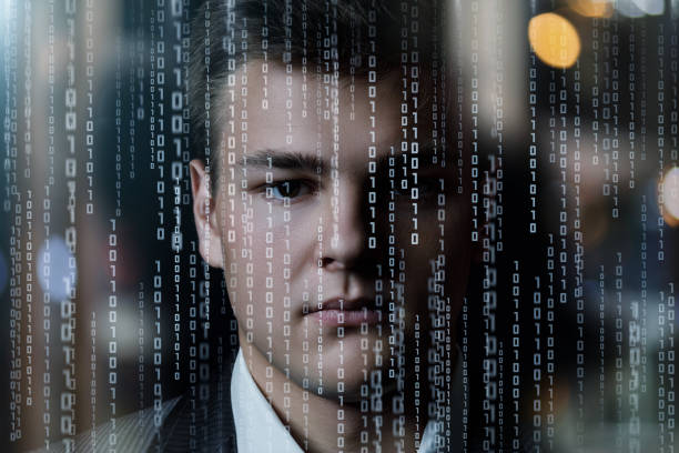 The face of a young businessman on a background of binary codes.