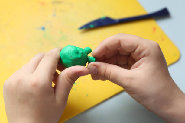 istock child's hands sculpt something from modelling clay 1248286381