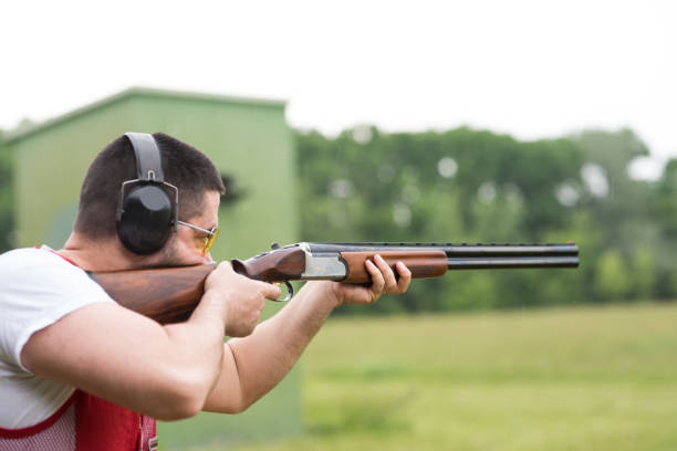 istock Man shooting skeet with a shotgun. Skeet shooting, trap shooting. 1248287331