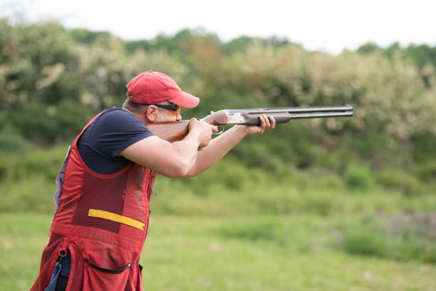 istock Man shooting skeet with a shotgun. 1248287372