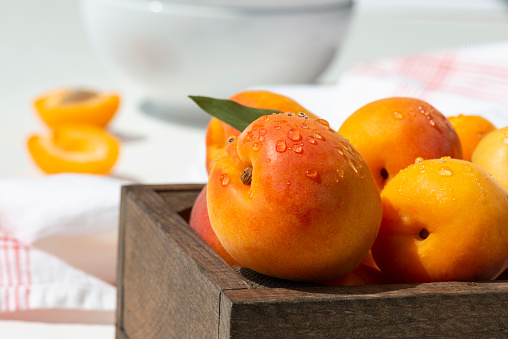 Delicious ripe Fresh juicy apricots on black background, close-up. Selection of healthy vegetarian food, detox or diet concept.