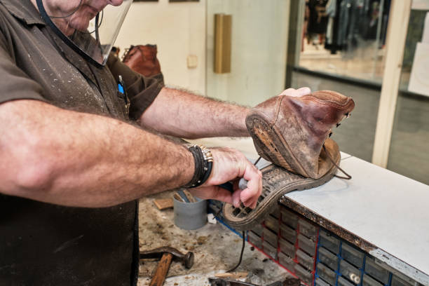 istock shoemaker man working in his shoe shop with mask 1248287392
