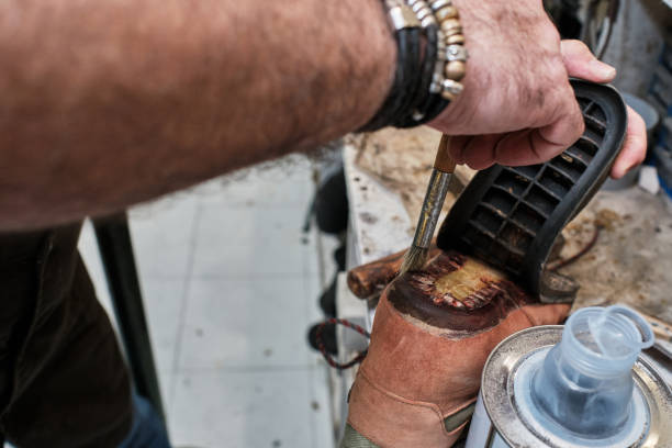 istock shoemaker man working in his shoe shop 1248287400