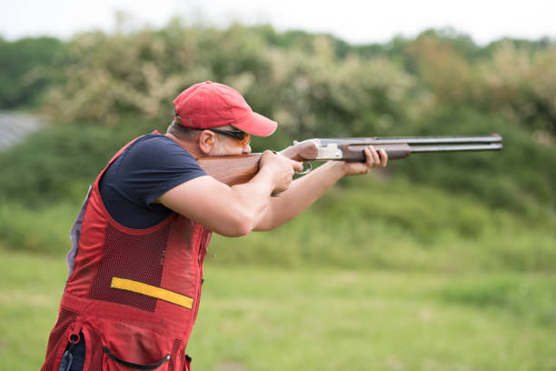 istock Man shooting skeet with a shotgun. 1248287438