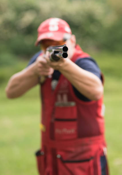 istock Man shooting skeet with a shotgun. Skeet shooting, trap shooting. 1248287455
