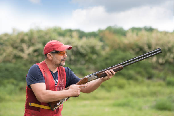 istock Man shooting skeet with a shotgun. 1248287969