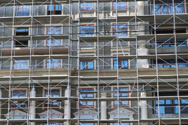 istock scaffolding at the facade of a building under construction, multi-storey building, without people 1248288615