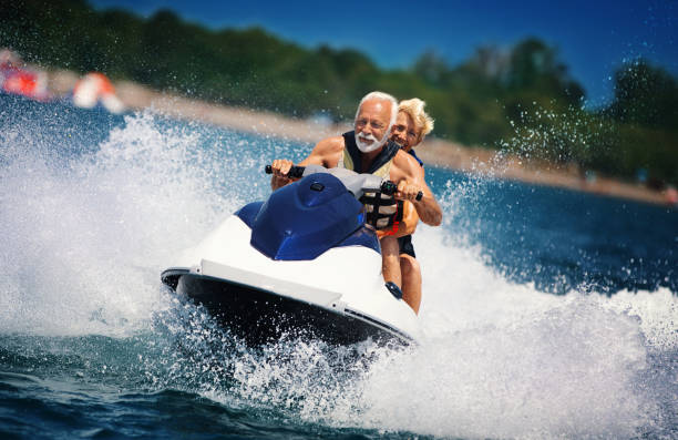 senior couple jet skiing. - nautical vessel motorboating motorboat fun imagens e fotografias de stock