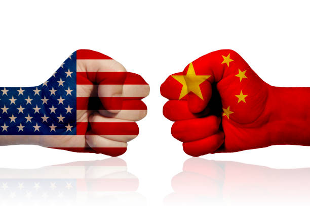 America vs China A fist with the American flag and a fist with the Chinese flag facing each other violence boxing fighting combative sport stock pictures, royalty-free photos & images