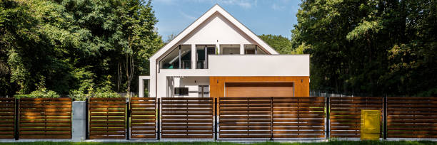 istock Modern house with fence, panorama 1248290011