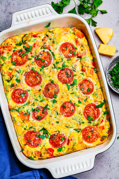 istock Baked egg omelet (frittata) with tomatoes and cheese in oven dish, Top View. 1248290489