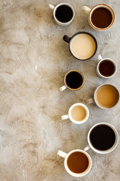 istock Many cups of coffee on beige table top-down copy space 1248291159