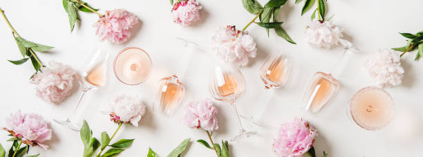 rose wine in glasses and blossom peonies over white background - pink champagne fotos imagens e fotografias de stock