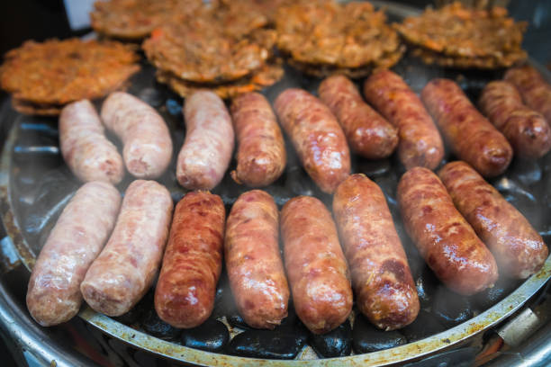istock Frying sausages on a grill on a chinese market stall 1248291576