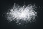 istock Abstract design of white powder cloud on dark background 1248291688