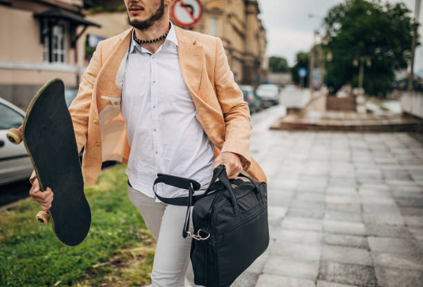 istock Modern young businessman with skateboard going to work 1248295815