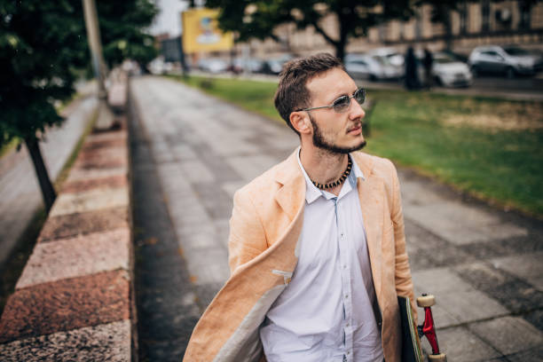 istock Modern young businessman with skateboard going to work 1248296025