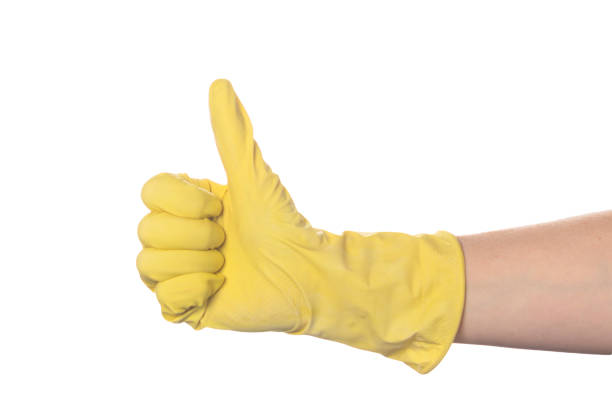 istock hand in a yellow glove holding a thumb like a sign 1248298025