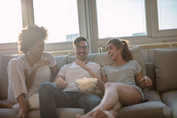 istock Friends eating popcorn and watching a movie 1248298042