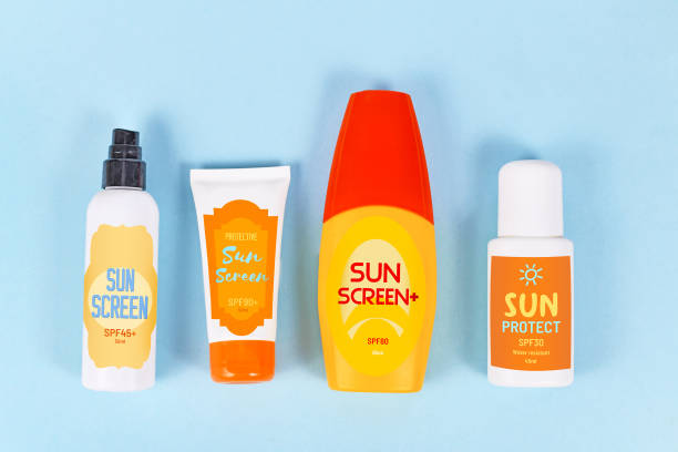 istock Various protective sun screen bottles and tubes with made up labels on blue background 1248298134