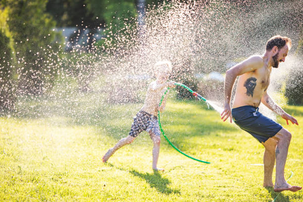 istock Little boy playing with water at backyard during quarantine 1248298141