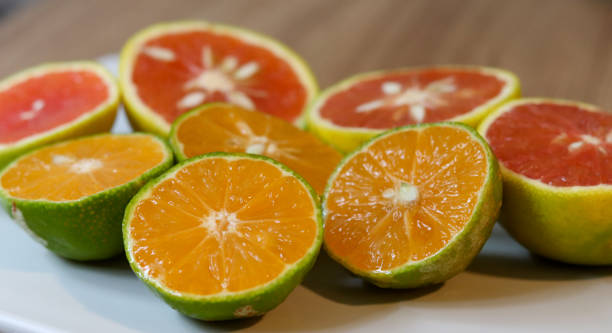 istock Beautiful lemons and grapefruits cut in half on a cutting board. 1248299081