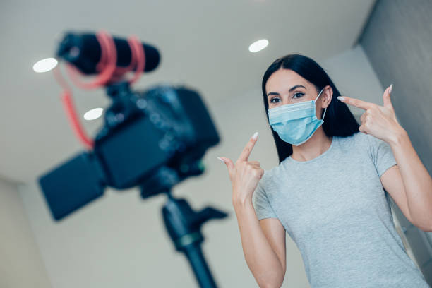 istock Young journalist demonstrating protective mask on her face 1248300248