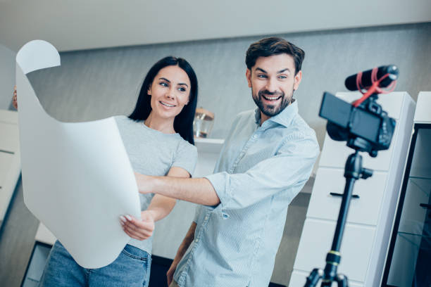 istock Gladsome colleagues recording video about their new project 1248300407