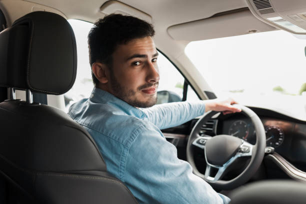 istock Handsome man driving a beautiful car 1248300660