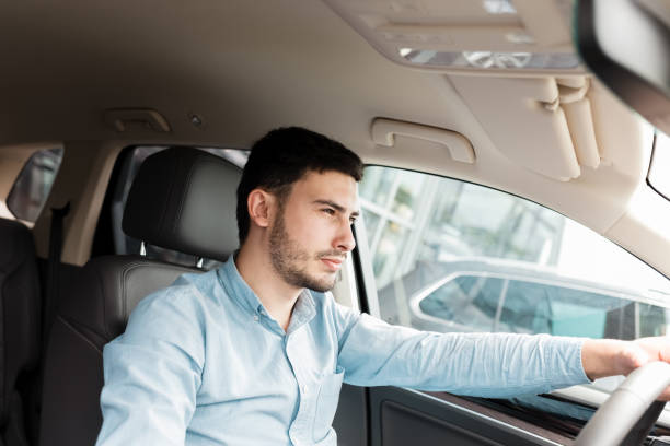 istock Successful man driving an expensive car 1248300681