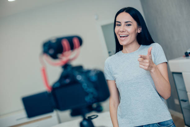 istock Happy young blogger making video at home and looking nice 1248302313