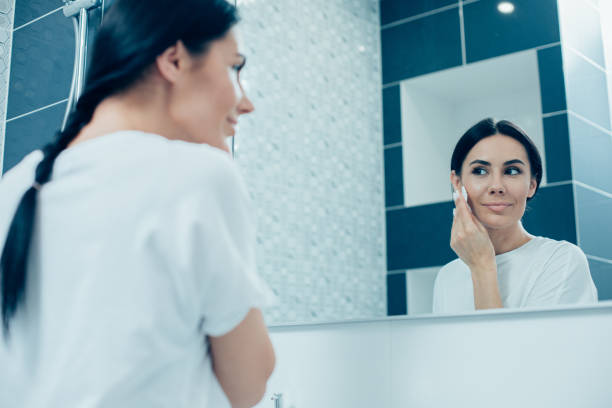 istock Smiling lady taking her make up off in the bathroom 1248305698