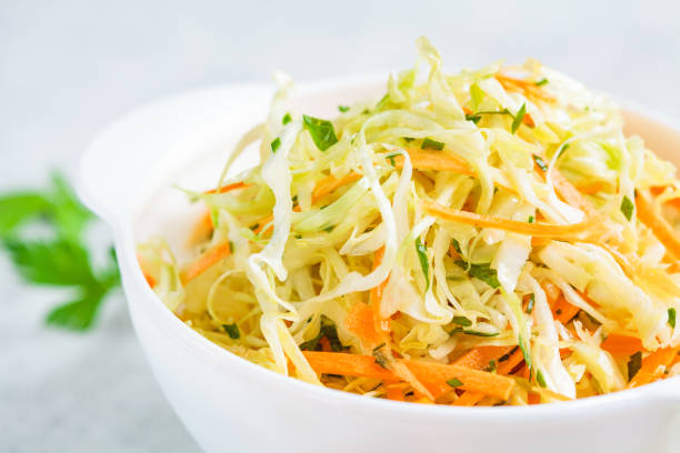 istock Fresh coleslaw salad with cabbage and carrots in white bowl. 1248306936