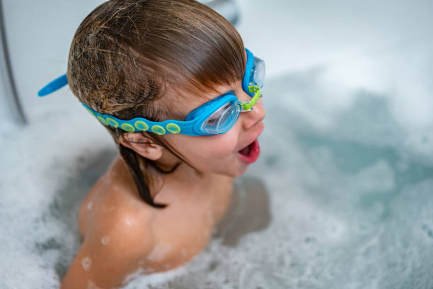 istock Boy with swimming goggles is taking bath in bathroom 1248310987