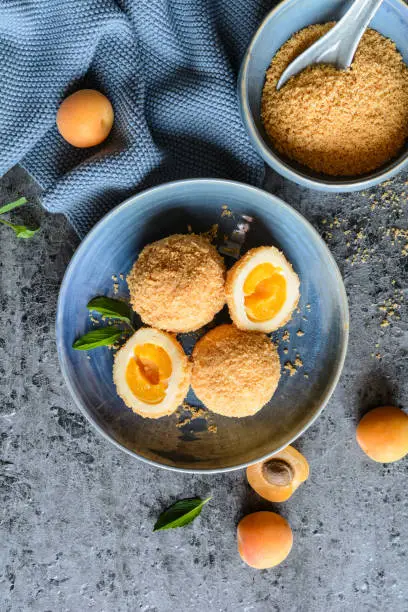 Marillenknödel – traditional Austrian sweet dumplings stuffed with apricot and coated with breadcrumbs