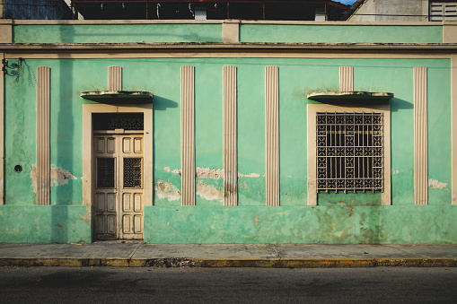 Facade of typical Mexican green colonial building in Merida, Yucatan, Mexico