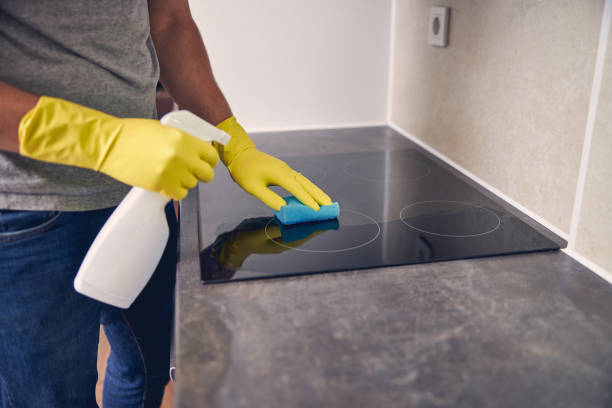 istock Hand in protective glove cleaning a stove 1248317395