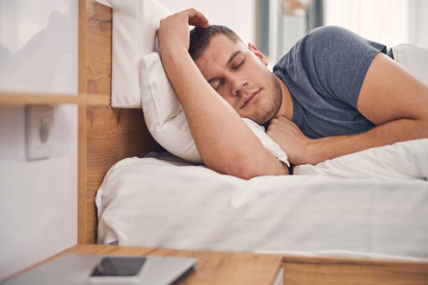 istock Attractive young man relaxing in bed at home 1248317405