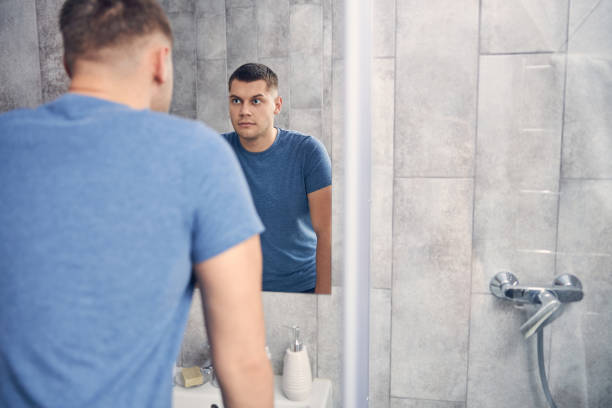 istock Young handsome man staying alone in bathroom 1248317424