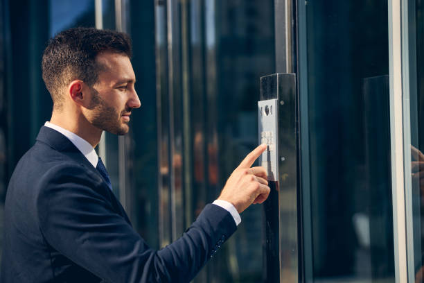 istock Serious brunette man trying to enter building 1248319768