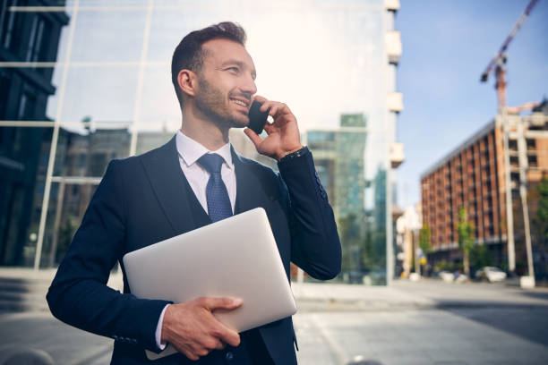 istock Slim brunette male talking on mobile phone outside 1248319805