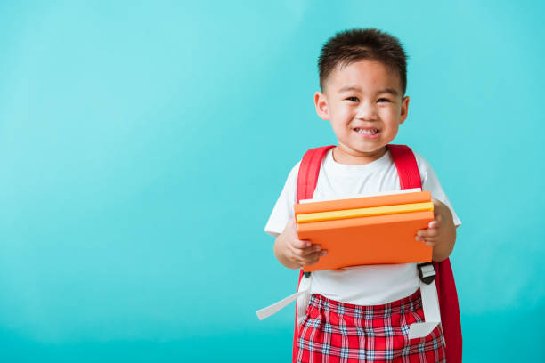 istock Kid from preschool kindergarten with book and school bag 1248321487
