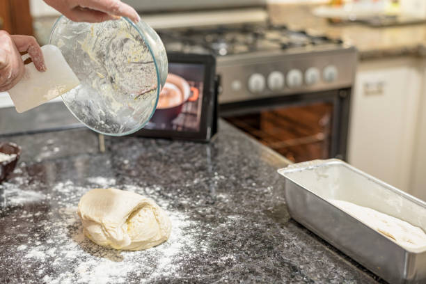 Homemade - Learning how to make bread dough with the aid of video on the tablet