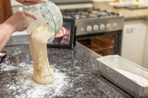 Homemade - Learning how to make bread dough with the aid of video on the tablet