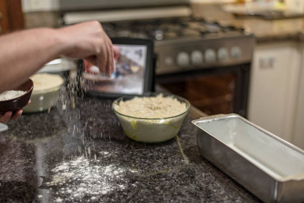 Homemade - Learning how to make bread dough with the aid of video on the tablet