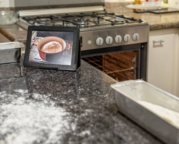 Homemade - Learning how to make bread dough with the aid of video on the tablet