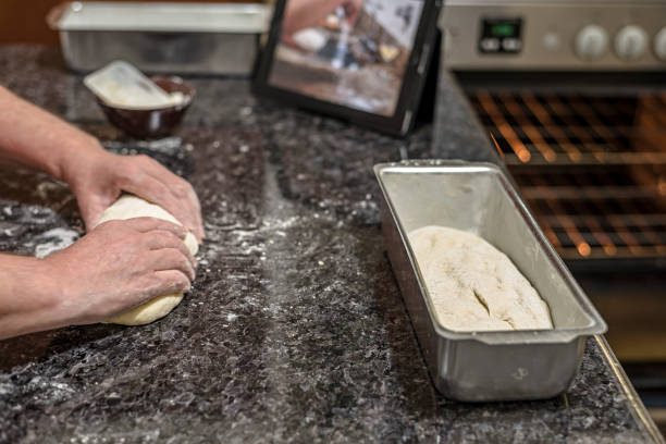 Homemade - Learning how to make bread dough with the aid of video on the tablet