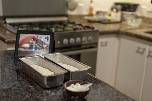 Homemade - Learning how to make bread dough with the aid of video on the tablet