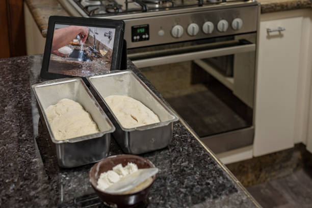 Homemade - Learning how to make bread dough with the aid of video on the tablet
